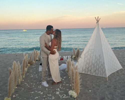 Happy couple kissing at beach picnic