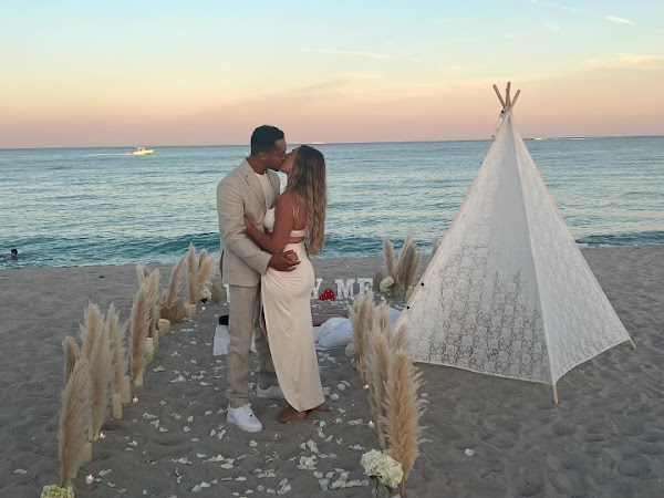 Happy couple kissing at beach picnic