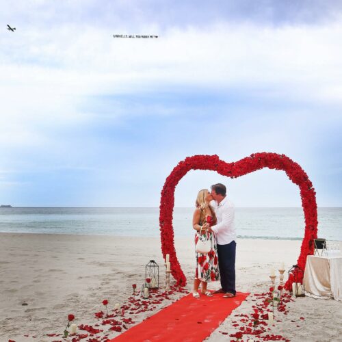 Proposal at Miami Beach with Flower arch and Airplane marry me letters