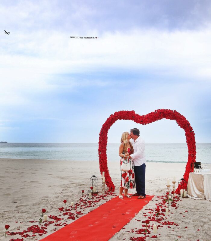 Proposal at Miami Beach with Flower arch and Airplane marry me letters