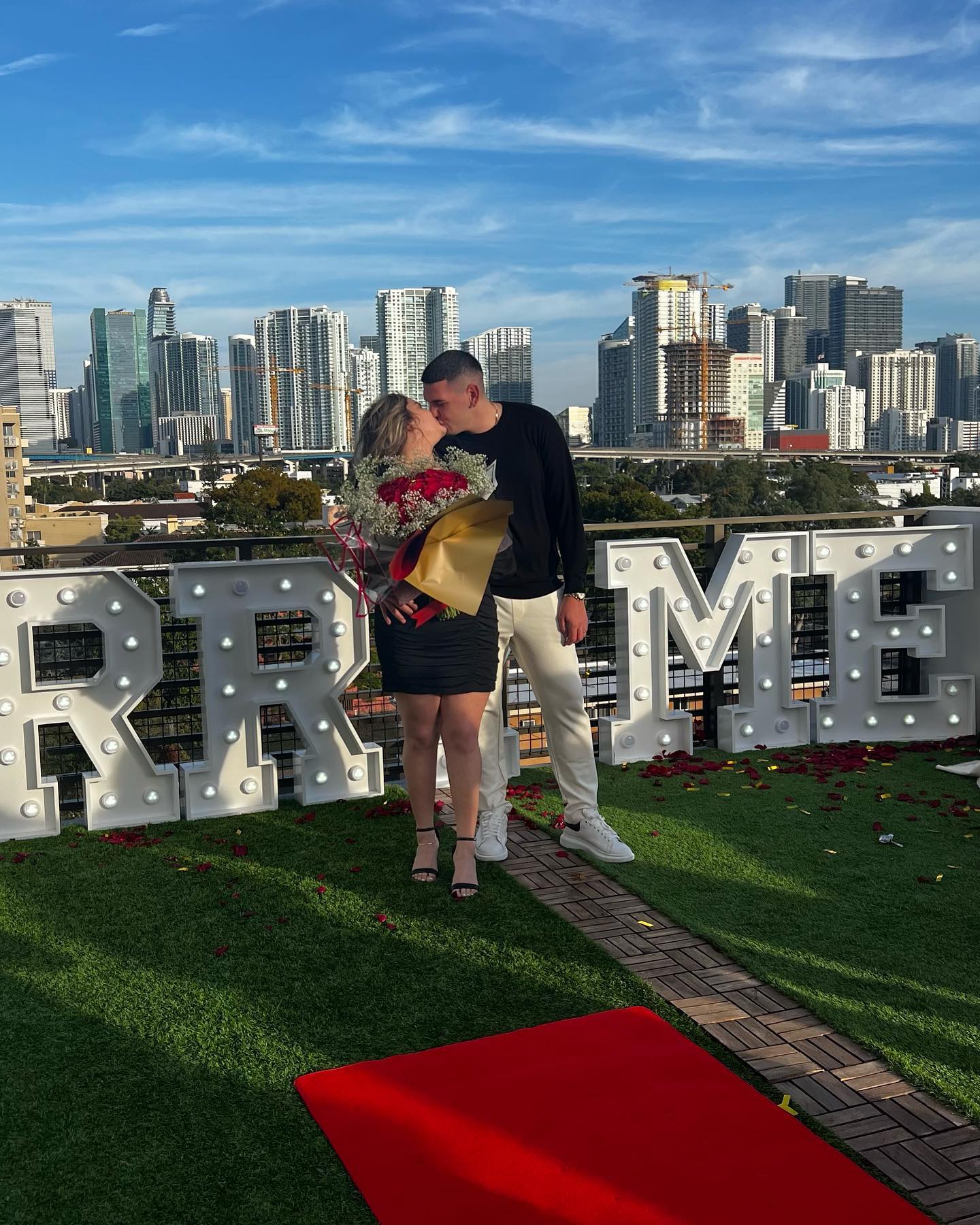 Rooftop Proposal with City Skyline