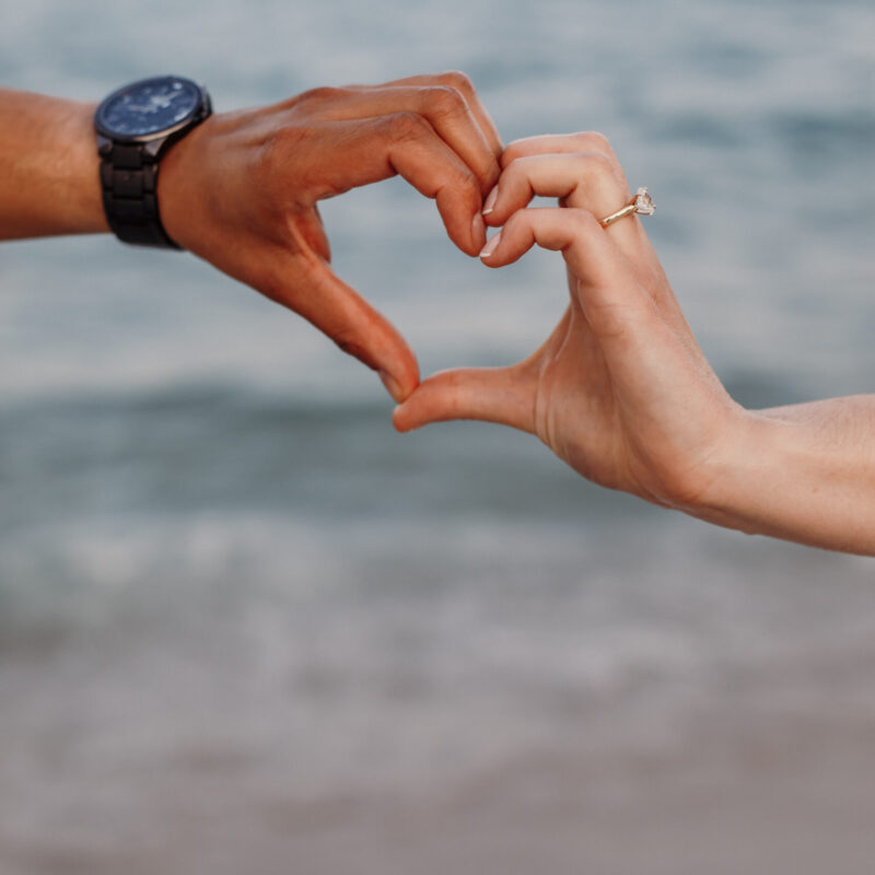 Couple Making Heart with Hands on Beach - Closeup