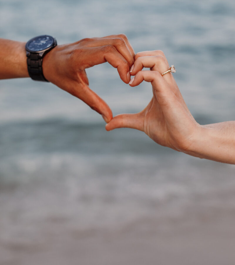 Couple Making Heart with Hands on Beach - Closeup