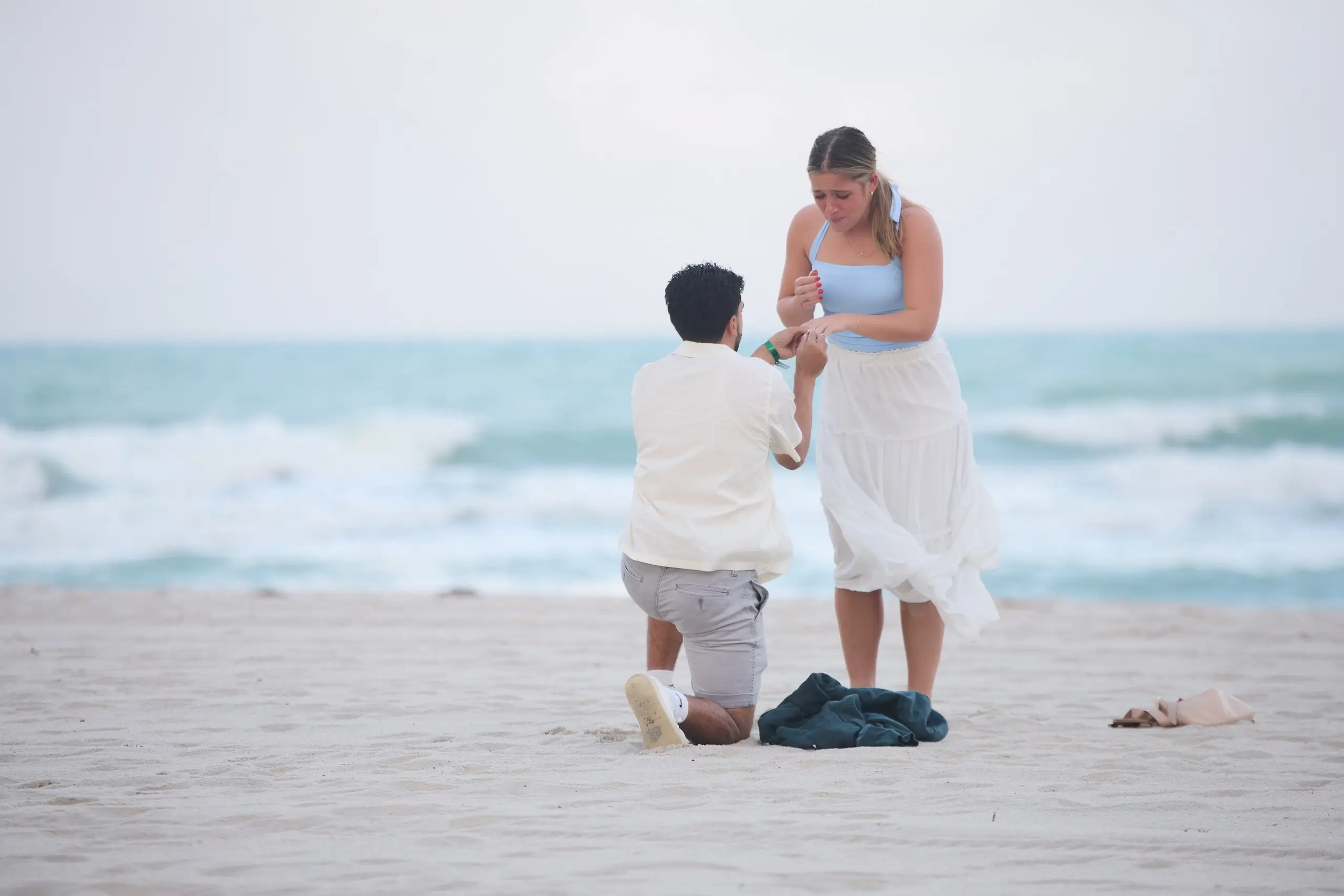 couple proposing on the beach