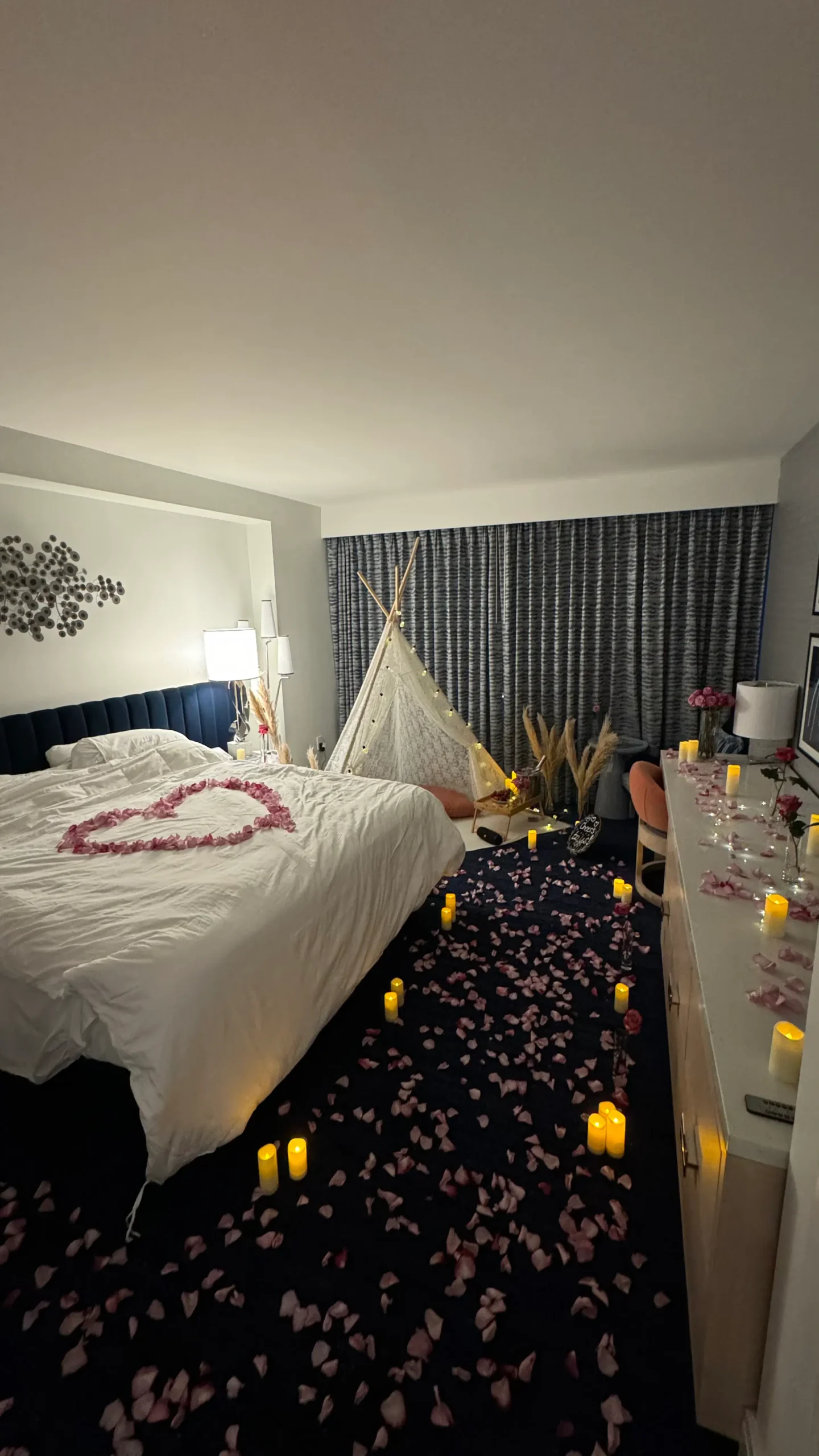 Hotel room makeover with candles, roses, and teepee